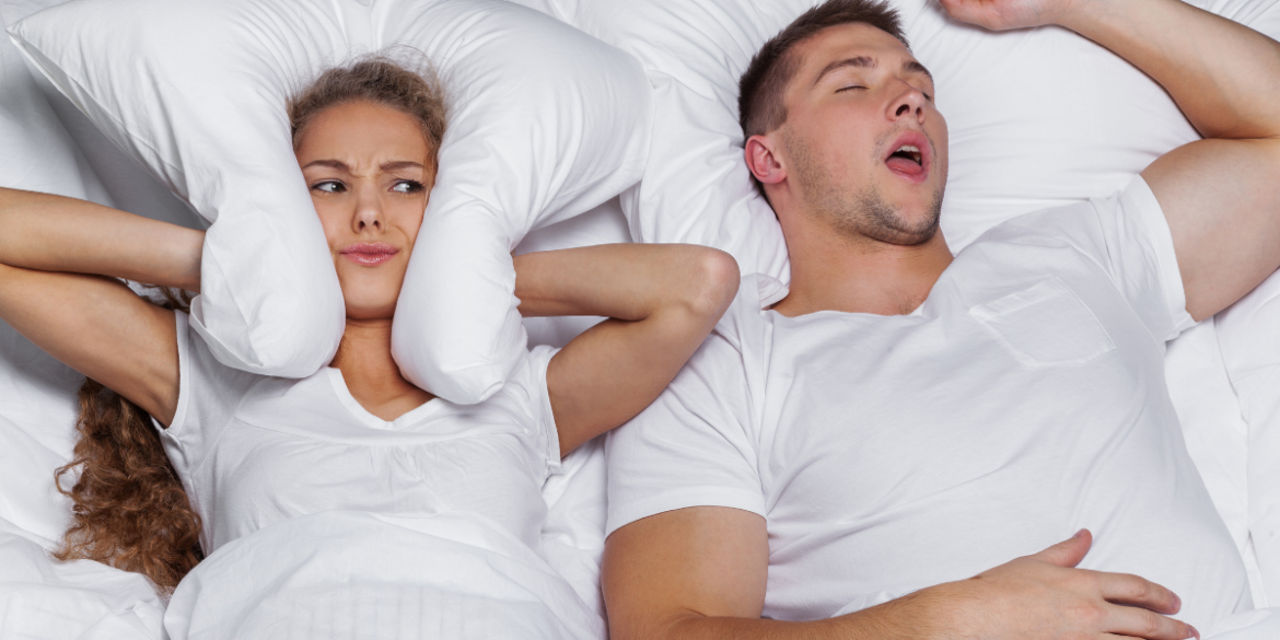 woman sleeping with a man who snores