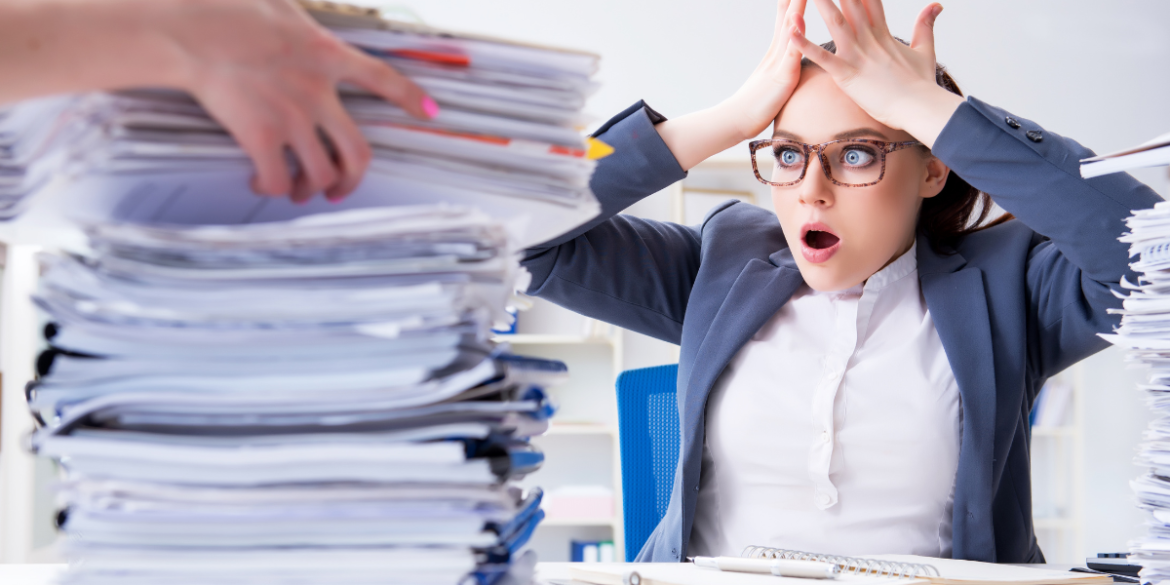 office worker overwhelmed by paperwork