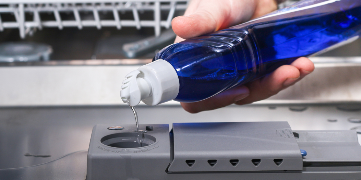 pouring rinse aid into a dishwasher